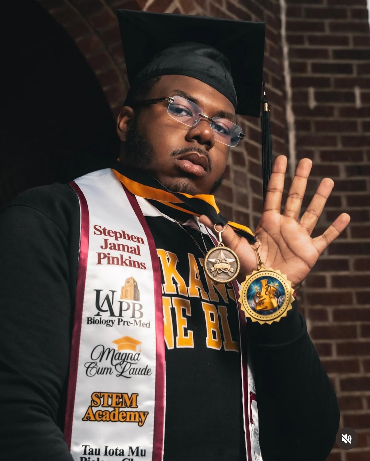 Graduation pictures with handmade, satin, krimson and cream storytelling. graduation sash for Magna Cum Laude.