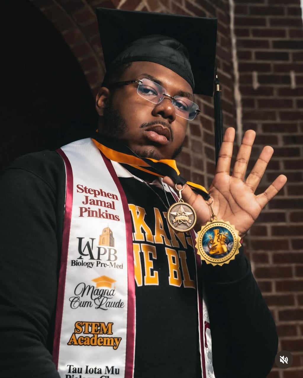 Graduation pictures with handmade, satin, krimson and cream storytelling. graduation sash for Magna Cum Laude. 