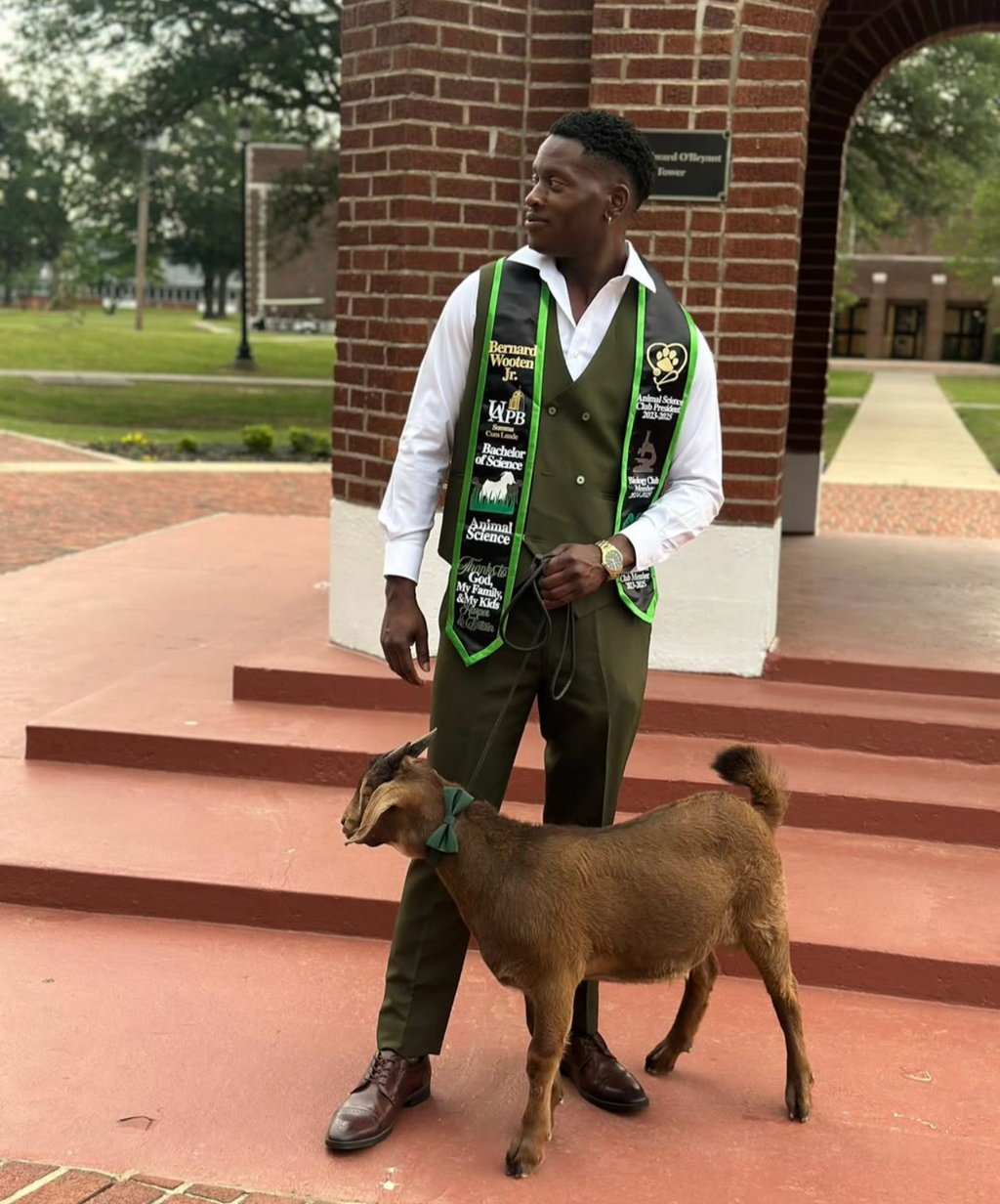 Graduation picture with a goat and custom, handmade, green and black, satin graduation stole